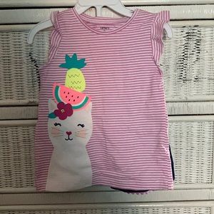 Purple & white top, blue shorts with purple fringe